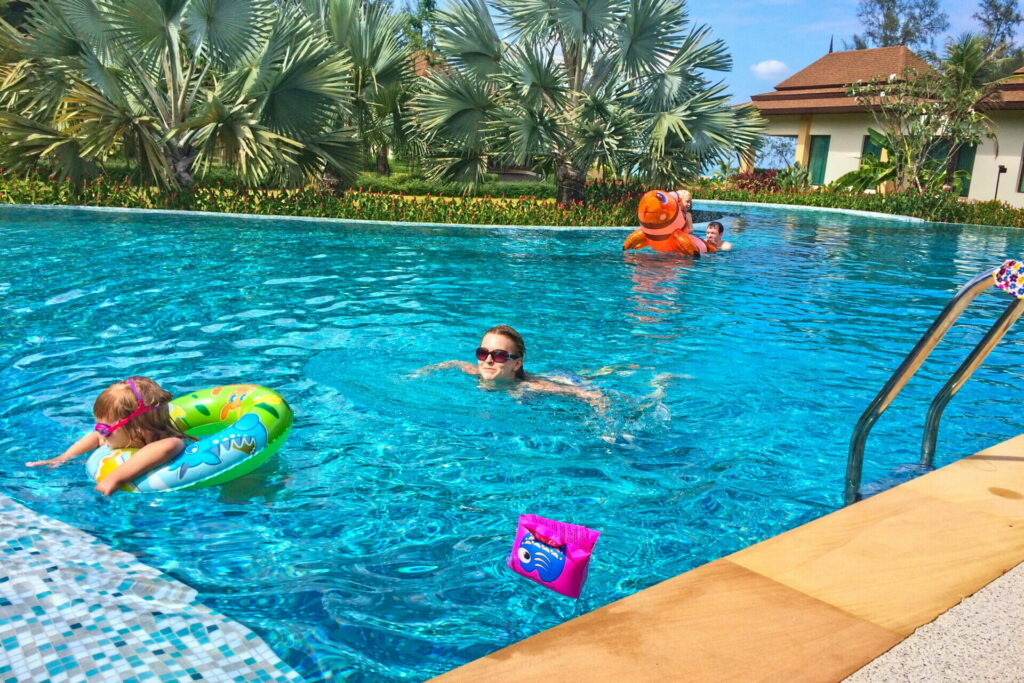 Swimming with kids in the main swimming pool of our 5* villa resort on Koh Kho Khao